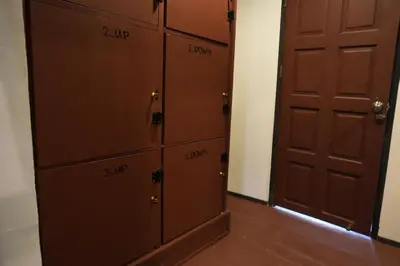 a locker room with two lockers and a door at Tropical Hostel in Phi Phi Don