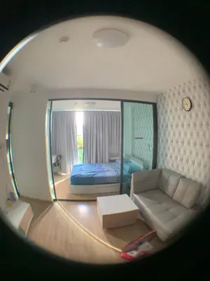 a room with a bed and a couch and a mirror at Cozy condo in Ban Tha Khreng