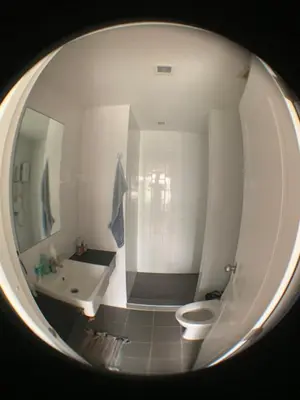 a bathroom with a white toilet and a sink at Cozy condo in Ban Tha Khreng