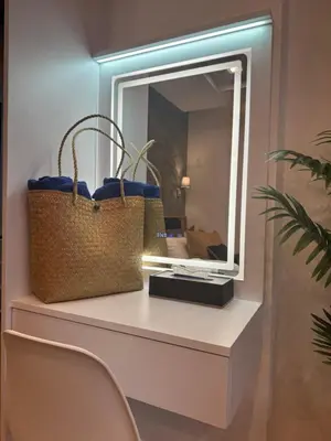 a mirror sitting on a shelf with two baskets at Luxury Seaview studio apartment at Karon beach in Karon Beach