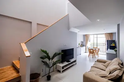 a living room with a couch and a tv at SPACIOUS AND BRIGHT 2BR TownHouse7 MonkeyHill in Ban Sam Kong