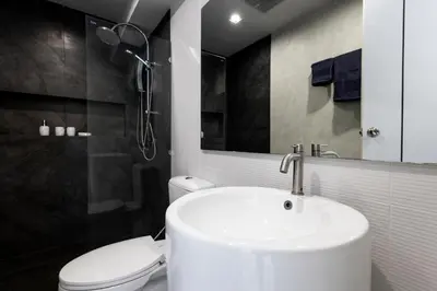 a bathroom with a white sink and a toilet at SPACIOUS AND BRIGHT 2BR TownHouse7 MonkeyHill in Ban Sam Kong
