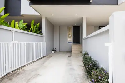 a hallway of a house with plants on the walls at SPACIOUS AND BRIGHT 2BR TownHouse7 MonkeyHill in Ban Sam Kong