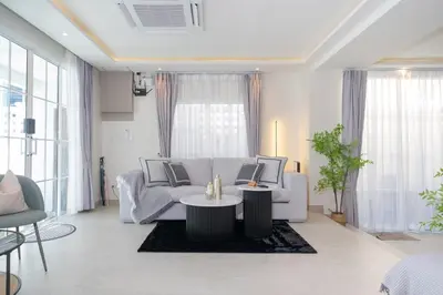 a living room with a white couch and a table at Patong private pool Villa 5BR 4Bath in Patong Beach