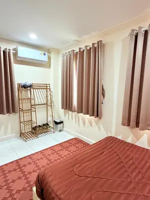a bedroom with a bed and curtains and a ladder at Dedbaicha cafe & Hostel Phuket old town in Phuket Town