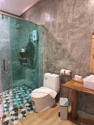 a bathroom with a shower and a toilet at Bulan Villa Koh Yao Noi in Ban Laem Sai