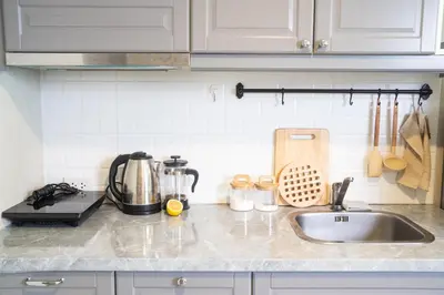 a kitchen counter with a sink and a mixer at Lovely Vlada in Nai Yang Beach