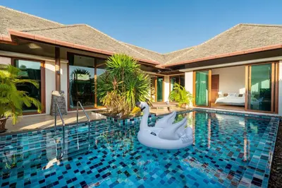 a swimming pool with an inflatable swan in a villa at 29 - Modern Pool Villa between Naiharn & Rawai in Ban Saiyuan (1)
