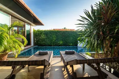 a patio with two benches and a swimming pool at 29 - Modern Pool Villa between Naiharn & Rawai in Ban Saiyuan (1)
