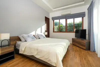 a bedroom with a bed and a flat screen tv at 29 - Modern Pool Villa between Naiharn & Rawai in Ban Saiyuan (1)