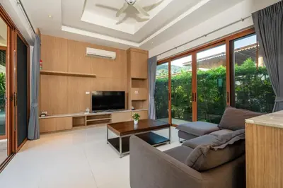 a living room with a couch and a tv at 29 - Modern Pool Villa between Naiharn & Rawai in Ban Saiyuan (1)