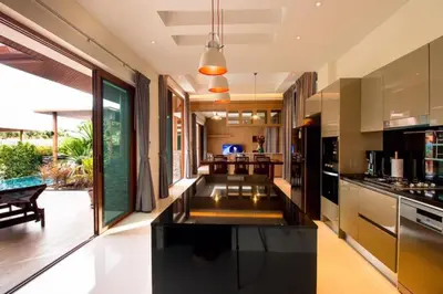 a kitchen with a black counter top in a room at 29 - Modern Pool Villa between Naiharn & Rawai in Ban Saiyuan (1)
