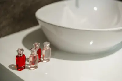 a white toilet with three small glass bottles on it at Квартира в The Title Halo 1 in Nai Yang Beach