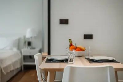a dining room table with two chairs and a bowl of fruit at Квартира в The Title Halo 1 in Nai Yang Beach