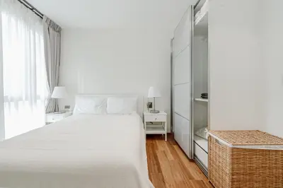 a white bedroom with a large bed and a window at Квартира в The Title Halo 1 in Nai Yang Beach