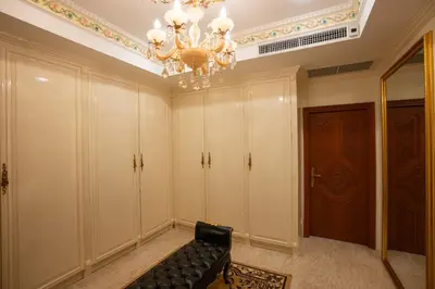 a living room with a chandelier and a couch at Two bedrooms Penthouse Seaview Rawai Beach Phuket in Phuket Town