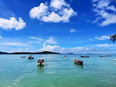 a group of boats sitting in the water at Two bedrooms Penthouse Seaview Rawai Beach Phuket in Phuket Town