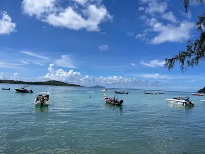 a group of boats floating in the water at Two bedrooms Penthouse Seaview Rawai Beach Phuket in Phuket Town