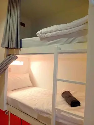 a bunk bed with a pillow on the bottom bunk at Go To Party Hostel and Bar Aonang in Ao Nang Beach