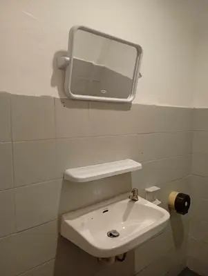 a bathroom with a sink and a mirror on the wall at Go To Party Hostel and Bar Aonang in Ao Nang Beach