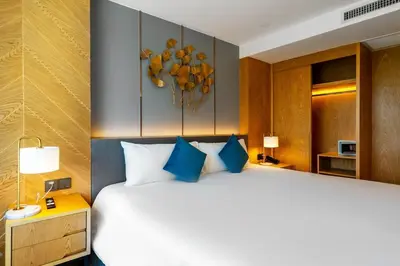 a bedroom with a large bed with blue pillows at Super 2Bdr Apartament La Vita Rawai Naiharn beach in Rawai Beach