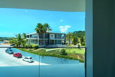 a house with a car parked in front of it at Super 2Bdr Apartament La Vita Rawai Naiharn beach in Rawai Beach