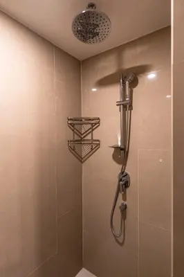 a shower with a shower head in a bathroom at Super 2Bdr Apartament La Vita Rawai Naiharn beach in Rawai Beach