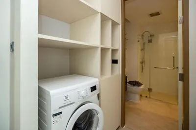 a washer and dryer in a bathroom with a toilet at Elegant Natural Stay at VV Patong Apartment A401 in Patong Beach