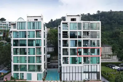 two tall white buildings next to a pool at Elegant Natural Stay at VV Patong Apartment A401 in Patong Beach