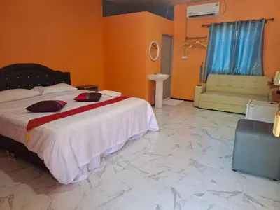 a bedroom with a large bed and a tiled floor at Fadel Residence in Ko Yao Yai