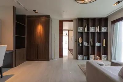 a living room with a couch and a book shelf at 33 - The Cove in Laem Singh Beach in Surin Beach