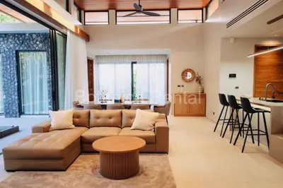a living room with a couch and a table at Villa M18 in Ban Pak Lak