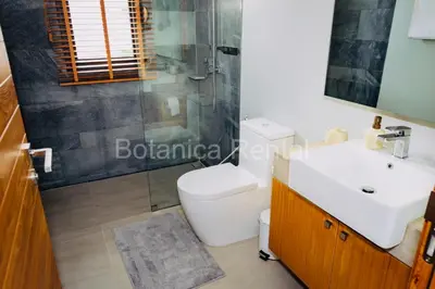 a bathroom with a white toilet and a sink at Villa M18 in Ban Pak Lak