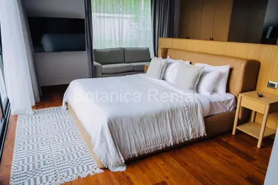 a bedroom with a large bed with white pillows at Villa M18 in Ban Pak Lak