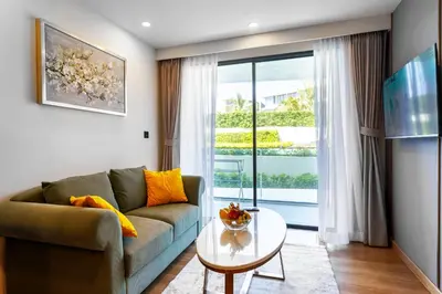 a living room with a couch and a table at Family 2 Bdr Suite in La Vita Rawai in Rawai Beach