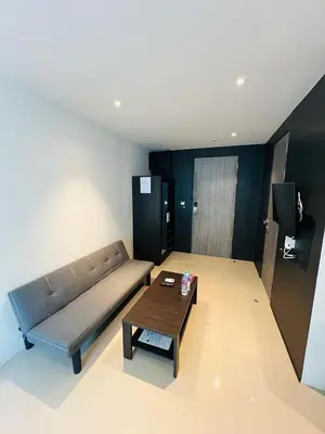 a living room with a couch and a coffee table at Utopia Kathu Condo in Phuket Town