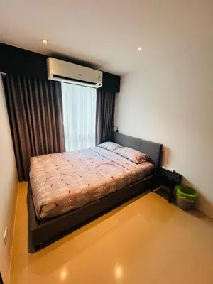 a small bedroom with a bed with a window at Utopia Kathu Condo in Phuket Town
