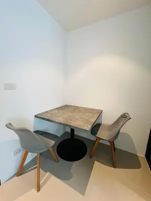 a table and two chairs in a room at Utopia Kathu Condo in Phuket Town