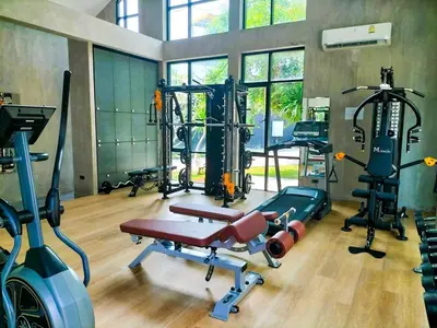 a gym with several treadmills and machines in it at Luxury KING 3 BR, Gym, Sauna, BBQ, AirCon, 8 min Beach, Tennis Court, Boating Ave in Ban Pak Lak
