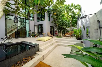 a house with a hot tub in a courtyard at Luxury KING 3 BR, Gym, Sauna, BBQ, AirCon, 8 min Beach, Tennis Court, Boating Ave in Ban Pak Lak