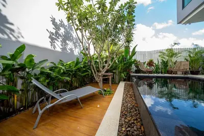 a patio with a pool and a bench next to at Luxury KING 3 BR, Gym, Sauna, BBQ, AirCon, 8 min Beach, Tennis Court, Boating Ave in Ban Pak Lak