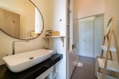 a bathroom with a white sink and a mirror at Luxury KING 3 BR, Gym, Sauna, BBQ, AirCon, 8 min Beach, Tennis Court, Boating Ave in Ban Pak Lak