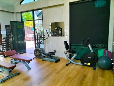 a gym with several exercise equipment in a room at Luxury KING 3 BR, Gym, Sauna, BBQ, AirCon, 8 min Beach, Tennis Court, Boating Ave in Ban Pak Lak