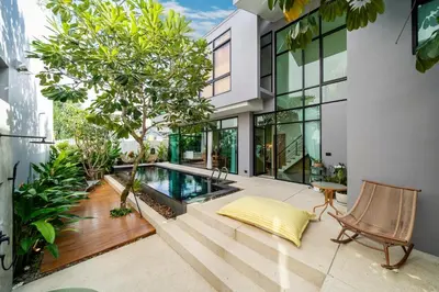 an image of a house with a swimming pool at Luxury KING 3 BR, Gym, Sauna, BBQ, AirCon, 8 min Beach, Tennis Court, Boating Ave in Ban Pak Lak