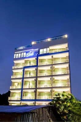 a tall building with a sign on the side of it at The Blue Hotel in Chalong
