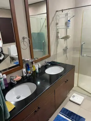 a bathroom with two sinks and a shower at Royal Apart Residence in Phuket Town