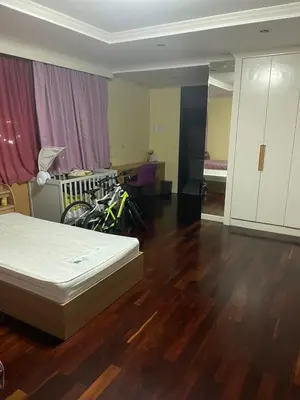 a bedroom with a bed and a room with aokedokedoked at Royal Apart Residence in Phuket Town
