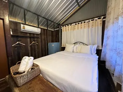 a bedroom with a large bed in a room at Cashew Garden House in Chalong