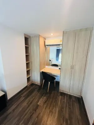 an empty room with a desk and a closet at Loft condo in Phuket