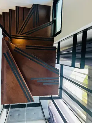 a spiral staircase in a house with windows at Loft condo in Phuket